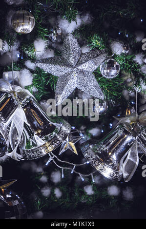 Christmas decorations Sparkling stars and Christmas bells. Accessories On the Christmas tree Stock Photo