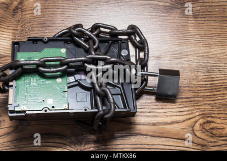 Information security concept, hard disk with chain and padlock Stock Photo