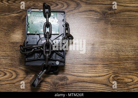 Information security concept, hard disk with chain and padlock Stock Photo