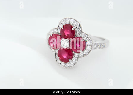 White Gold Ring With Rubies And Diamonds On Soft White Background Stock Photo