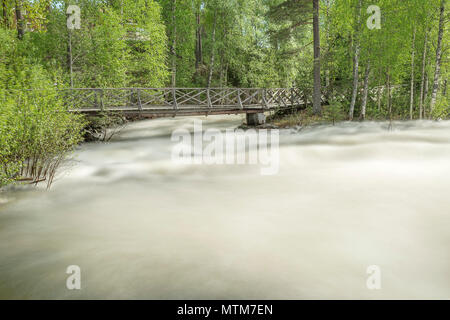 The rapids at Renforsen in Vindeln, Sweden with a wooden bridge. Stock Photo