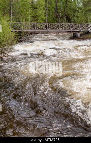 The rapids at Renforsen in Vindeln, Sweden with a wooden bridge. Stock Photo