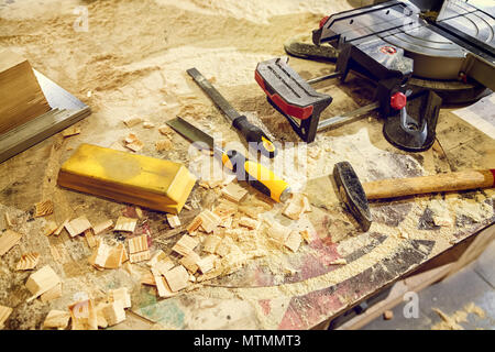 Topl view of carpenter tools:hammer,meter,nails,shavings, and chisel  equipment set on wooden table Stock Photo