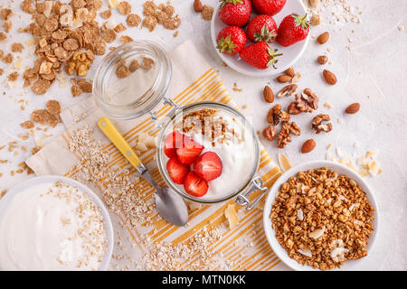 Healthy breakfast concept. Granola or muesli with yogurt and fresh strawberries. Stock Photo