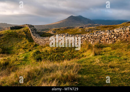 Sunset view of the Hardknott Roman Fort in the English Lake District and the Scafell Mountain Range in the background. Stock Photo