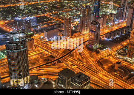 Dubai sunset panoramic view of Sheike Zayed road crossroad. Dubai is super modern city of UAE, cosmopolitan megalopolis. Stock Photo