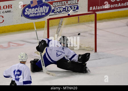 Air Force Goalie Senior Airman Stanislav Barilov, from Magadan, Russia, can only watch as another Army shot finds the net in the third period of the 4th Annual Army vs. Air Force Hockey Game Jan. 7, 2017, at the Sullivan Arena in Anchorage, Alaska. The game is played annually between teams made up of service members assigned to Joint Base Elmendorf-Richardson, Alaska. Army's 5-0 shutout of the Air Force team tied the series at 2-2.  (Army Photo/John Pennell) Stock Photo