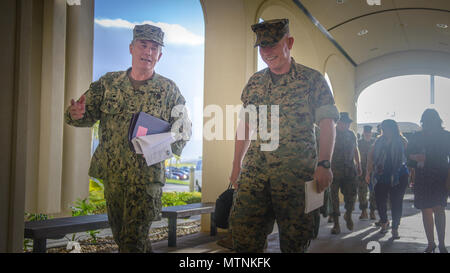 U.S. Marine Corps Lt. Gen. Lawrence Nicholson (right), Commanding General, III Marine Expeditionary Force,  walks into US Naval Hospital Guam (USNH Guam) with the hospital's Commanding Officer, Capt. Dan Cornwell (left).  Lt. Gen. Nicholson visited the hospital to gain a better understanding of Navy Medicine's capabilities on Guam.  (U.S. Navy photo by USNH Guam Public Affairs/Released) Stock Photo