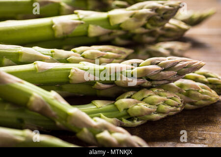 Green Asparagus in Juta Bag on White Wooden Table Stock Photo