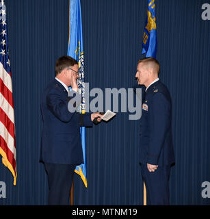 Brig. Gen. Russ Walz, Director of Doint Staff, South Dakota National Guard, administers the officer's oath to Col. Quenten M. Esser, 114th Operations Group commander, during Esser's promotion ceremony Jan. 8, 2017 Joe Foss Field, S.D. Esser assumed command of the 114th Operations Group from Col. Gregory Lair on May 1, 2016.(U.S. Air National Guard photo by Master Sgt. Luke Olson/Released) Stock Photo