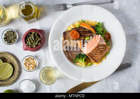 Grilled Salmon Fillet with Vegetables on White Plate Stock Photo