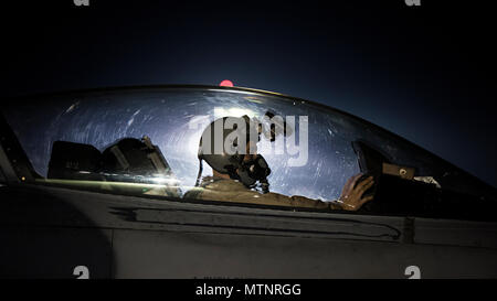 Capt. David, 79th Expeditionary Fighter Squadron pilot, taxis an F-16 Fighting Falcon before a night mission Jan. 13, 2017 at Bagram Airfield, Afghanistan. To become a pilot, David went to school while working as a maintainer, through a deployment to Balad Airfield, Iraq and temporary duties where he was often gone for three weeks out of every month. (U.S. Air Force photo by Staff Sgt. Katherine Spessa) Stock Photo