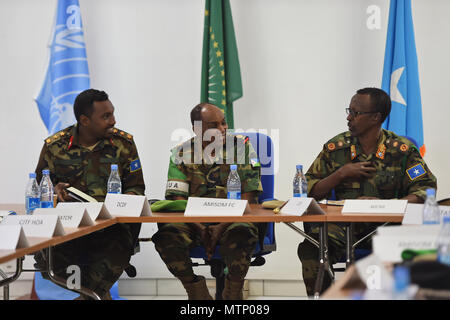 Somali National Army Chief of Defense Forces Maj. Gen. Mohammed Adan Ahmed, right, and Chief of Staff Col. Ahmed Mohammed, left, converse with African Union Mission in Somalia Force Commander Lt. Gen. Osman Noor Soubagleh during the SNA Symposium in downtown Mogadishu, Jan. 12, 2017. The symposium is part of an ongoing international effort to aid security conditions throughout Somalia by fostering the growth and revitalization of the national military defense force, which disbanded following the collapse of the country’s central government in 1991. Stock Photo