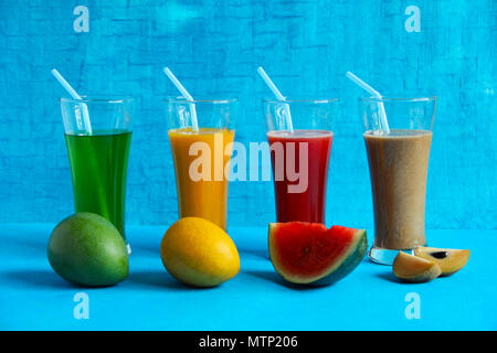 Fruits like raw alphonso mango, ripe alphonso mango, watermelon, chikoo or sapota and their juices Stock Photo