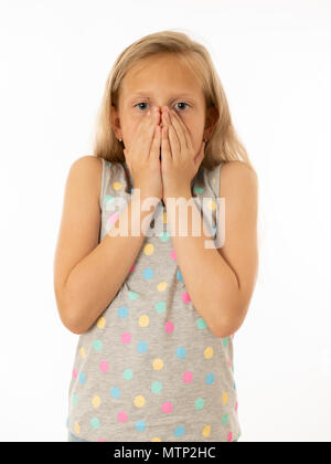 Close up portrait. Cute, scared young kid with a shocked, surprised face hands covering her mouth with fear. Human emotions, body language and facial  Stock Photo