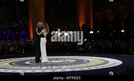 United States President Donald J. Trump and First Lady Melania Trump dances in the center of the stage during the Salute to Our Armed Services Ball at the National Building Museum, Washington, D.C., Jan. 20, 2017. The event, one of three official balls held in celebration of the 58th Presidential Inauguration, paid tribute to members of all branches of the armed forces of the United States, as well as first responders and emergency personnel. (DoD photo by U.S. Army Spc. Ayla Seidel) Stock Photo
