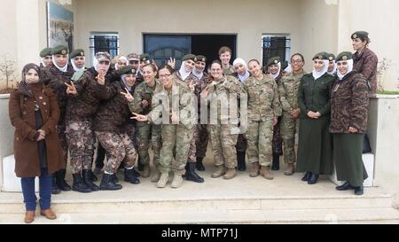 Female Maryland and Virginia National Guard Soldiers from the 29th Infantry Division pose with female soldiers from the Jordan Armed Forces- Arab Army Female Company For Special Security Tasks during an engagement Jan. 17, 2017, near Amman, Jordan. While in Jordan from September 2016- July 2017, Soldiers of Task Force 29 planned and coordinated multiple engagements with JAF female soldiers, providing both U.S. and Jordanian military women the opportunity to exchange information and best practices on leadership, communications skills and various women's empowerment topics. (Courtesy photo) Stock Photo