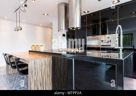Black high-gloss open kitchen in modern style Stock Photo