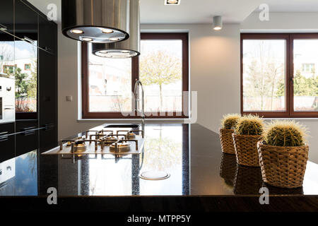 Beautiful and luxurious black high-gloss kitchen in new villa Stock Photo