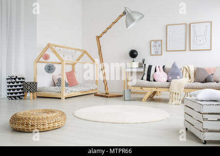Creative scandinavian child's bedroom in modern apartment with big wooden lamp Stock Photo
