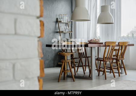Bricks and concrete in modern dining room Stock Photo