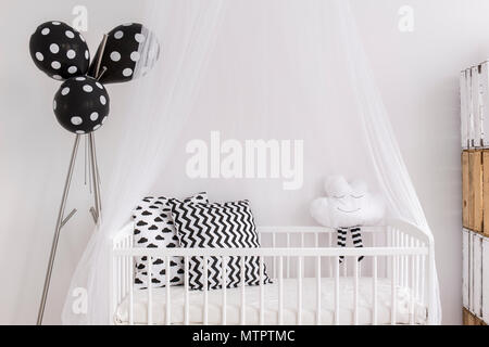 Shot of a crib in a modern black and white baby room Stock Photo