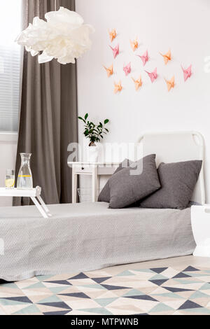 Origami arts on the wall in bright bedroom Stock Photo