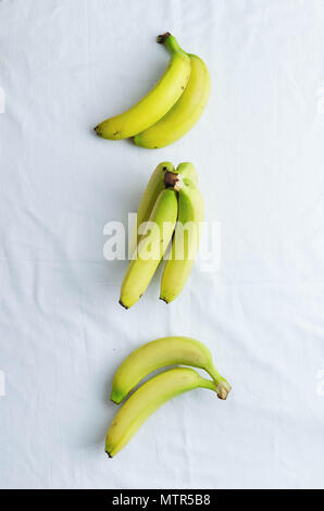 Multiple bananas over white cloth, above view Stock Photo