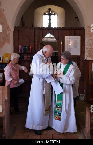 Bishop retired Tony Foottit and Revd Rev Penny Goodman female parish priest of the Church of England.Interior of church  2010s 2018  HOMER SYKES Stock Photo