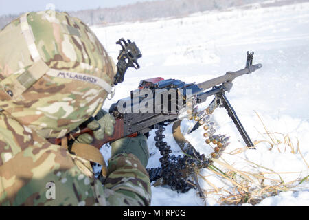 Sgt. David McLaughlin of Yukon, Oklahoma fires a PKM machine gun during instructor standardization training at the International Peacekeeping and Security Center, near Yavoriv, Ukraine, on Jan. 19. McLaughlin is a member of Company A, 1st Battalion, 179th Infantry Regiment, 45th Infantry Brigade Combat Team. He and other members of Company A were instructed on use of the AKM rifle and PKM machine gun to familiarize themselves with the weapons before they begin partnering with and mentoring Ukrainian army combat training center staff. (Photo by Sgt. Anthony Jones, 45th Infantry Brigade Combat T Stock Photo