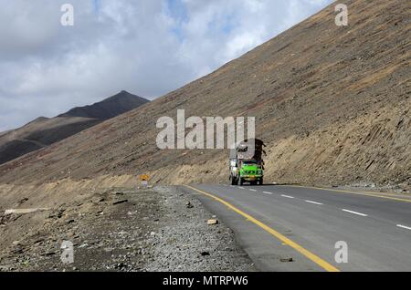 Green Bedford decorated goods truck on Karakoram Highway amid mountains Babusar Pass north Pakistan Stock Photo