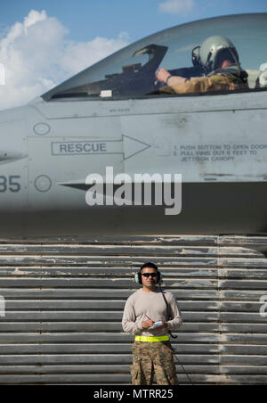 Senior Airman Kevin Ly, a 455th Expeditionary Aircraft Maintenance Squadron weapons load crew member, performs a post-flight check April 25, 2017, on Bagram Airfield, Afghanistan. F-16 Fighting Falcons from the 555th Fighter Squadron, Aviano Air Base, Italy, deployed to Bagram Airfield as part of a constant rotation of fighter aircraft. The 555th EFS, who was last here in 2015, provides counterterrorism to enable a successful train, advise and assist campaign. Stock Photo