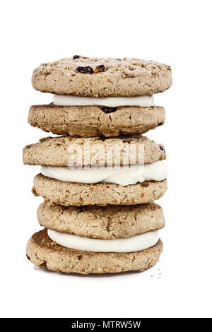 Carrot cake cookies sandwiches stuffed with cream cheese icing isolated over a white background with light shadow. Stock Photo