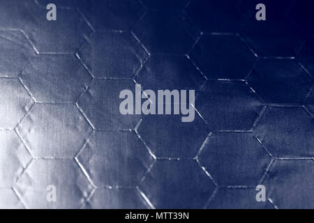 Macro view of aluminium foil with an hexagonal pattern and a blue filter applied during processing Stock Photo