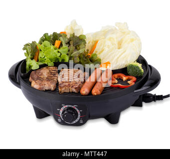 Grill steak on an electric stove. Pork neck fried on small electric grill.  Home cooking. Healthy barbecue. Catering to friends. Electric grilling.  Stock Photo