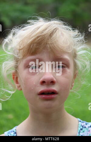 Portrait of a young blonde girl crying Stock Photo