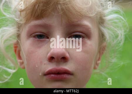 Closeup of a young girl with tears rolling down her cheek Stock Photo