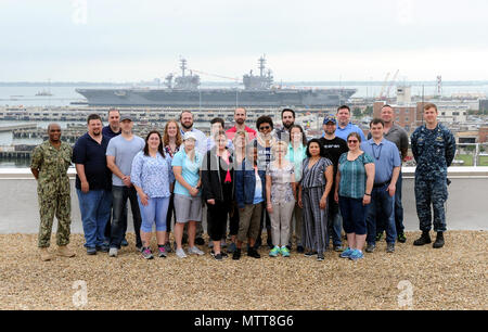 180522-N-PX557-013  NORFOLK, Va.  (May 22, 2018)  Naval Supply Systems Command (NAVSUP) Business Systems Center (BSC) personnel pose for a group photo as USS Abraham Lincoln (CVN 72) and USS George H.W. Bush (CVN 77) are moored pier side at Naval Station Norfolk, as part of NAVSUP BSC’s Meet the Fleet event in the Hampton Roads, Va., area of operation, May 22. The four-day event was held May 21-24 and served as an opportunity for personnel to directly engage with Sailors serving in the area who use supply, logistic, and financial systems supported by NAVSUP BSC. The event also provided insight Stock Photo