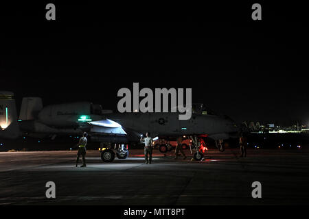 KANDAHAR, Afghanistan (May 21, 2018) -- U.S. Air Force 122nd Fighter Wing weapon loaders prepare an A-10 Thunderbolt II for flight at Kandahar Airfield, Afghanistan, May 21, 2018. The Thunderbolt II can be serviced and operated from austere bases with limited facilities near battle areas. The aircraft are deployed to Afghanistan in support of the Resolute Support mission and Operation Freedom's Sentinel. (U.S. Air Force Photo by Staff Sgt. Corey Hook) Stock Photo