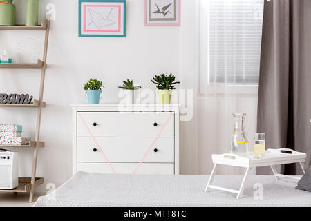 Stylish room interior with chest of drawers and round mirror Stock Photo