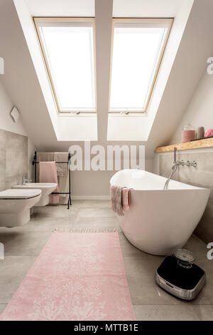 New design attic bathroom with big window, bathtub, toilet and bidet Stock Photo
