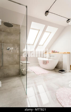 Spacious  new design  attic bathroom with glass walk in shower, bathroom and high gloss tiling Stock Photo