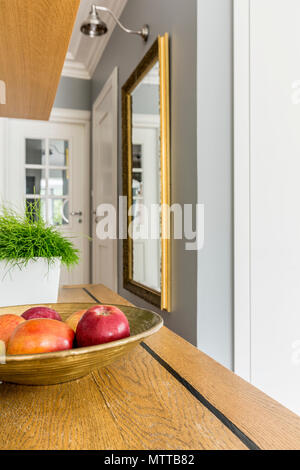 Contemporary interior with grey walls, white details and wooden worktop Stock Photo