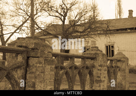 old stone fence and abandoned house in village Stock Photo