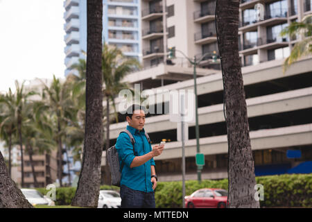 Man using mobile phone in city street Stock Photo