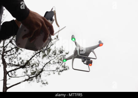 Man operating a flying drone Stock Photo