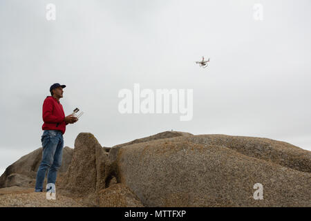 Man operating a flying drone Stock Photo