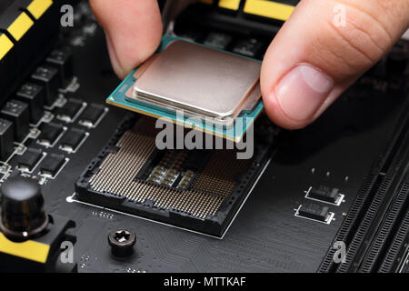 Installing modern central processor unit into motherboard Stock Photo