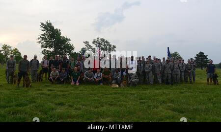 Members of Team McConnell pose for a photo May 16, 2018, at the Krueger Outdoor Track on McConnell Air Force Base, Kansas, May 16, 2018. Members gathered in the morning to begin a ruck march in honor of fallen security forces and Office of Special Investigations brethren during National Police Week. (U.S. Air Force by Airman 1st Class Alan Ricker). () Stock Photo