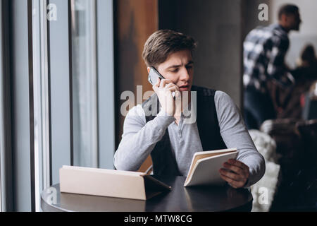 Young man with tablet pc computer at cafe Stock Photo